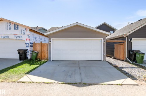 Detached garage with a concrete driveway and gray siding - 4306 Prowse Link Link Sw, Edmonton, AB 