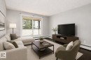 Hardwood flooring, light gray wall paint, and white trim - #203 2624 Mill Woods Rd E Nw, Edmonton, AB 