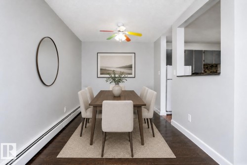 Hardwood-finish flooring with radiant heating, complemented by an overhead ceiling fan - #203 2624 Mill Woods Rd E Nw, Edmonton, AB 