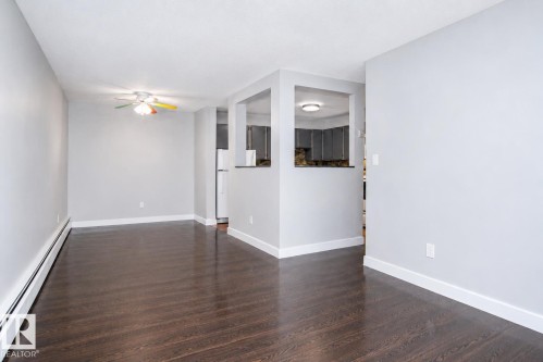 Hardwood-finish flooring, light gray wall paint, and white trim throughout - #203 2624 Mill Woods Rd E Nw, Edmonton, AB 