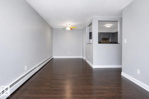 Dark wood-finish flooring with light gray walls - #203 2624 Mill Woods Rd E Nw, Edmonton, AB 