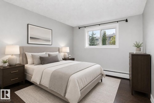 Dark wood-finish flooring with light wall tones - #203 2624 Mill Woods Rd E Nw, Edmonton, AB 