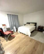 Light wood-finish flooring complements neutral wall tones - 