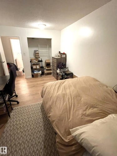 Wood-finish flooring throughout, with a recessed open closet providing storage - #D1 1 Garden Grove Nw, Edmonton, AB 