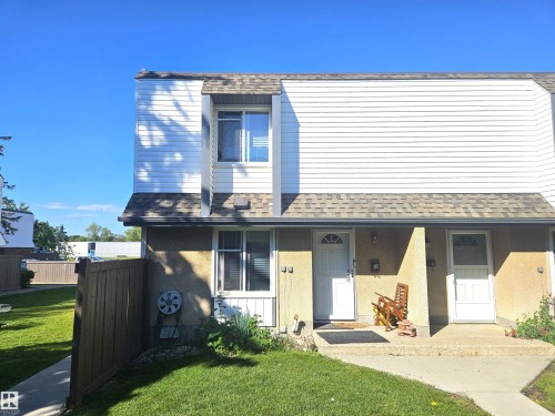 Two-story exterior with white siding and a shingle roof - #D1 1 Garden Grove Nw, Edmonton, AB 