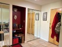 Tile flooring, mirrored closet doors, built-in shelving, and light wood-finish interior doors - #112 4404 122 St Nw, Edmonton, AB 