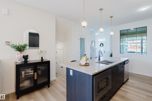 Kitchen island with integrated stainless steel microwave and dishwasher - 7017 52 Avenue, Beaumont, AB 