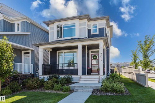 Two-story residence with a covered front porch featuring white pillars - 7017 52 Avenue, Beaumont, AB 