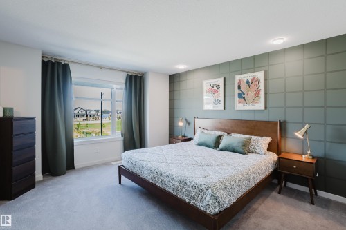 Wall-to-wall carpeting with a patterned accent wall - 7017 52 Avenue, Beaumont, AB 