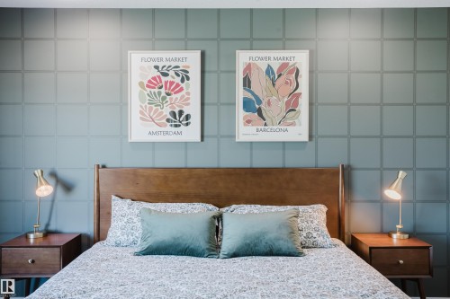Decorative wall treatment with a geometric pattern and a wood-finish headboard - 7017 52 Avenue, Beaumont, AB 