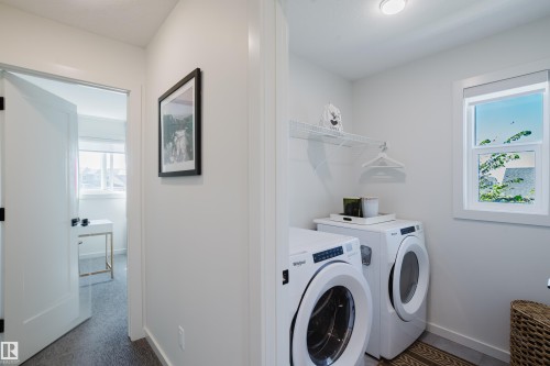 Laundry area with a window, shelving, and a bright interior - 7017 52 Avenue, Beaumont, AB 