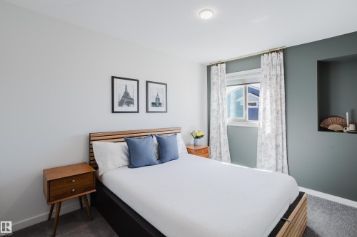 Recessed ceiling lighting, a window with natural light, a built-in wall niche, and carpeted flooring - 7017 52 Avenue, Beaumont, AB 