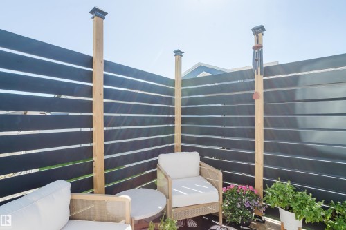 Outdoor area with slatted horizontal fencing, wood fence posts, and post caps - 7017 52 Avenue, Beaumont, AB 
