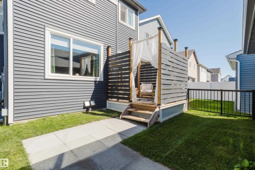 Exterior siding with white trim and a single window - 7017 52 Avenue, Beaumont, AB 