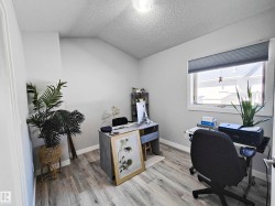 Light-toned wood-finish flooring, a window with horizontal blinds, and a built-in ceiling light fixture - 