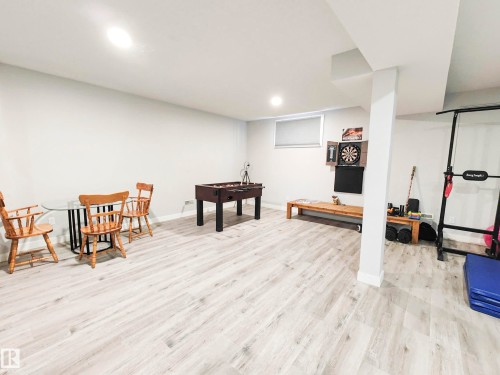 Recessed lighting, light wood-finish flooring, and a window with roller shade - 215 Peter Close Nw, Edmonton, AB 