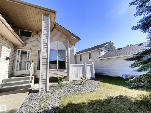 Siding exterior with a covered entry and an arched window - 215 Peter Close Nw, Edmonton, AB 