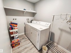 Wood-finish flooring with light gray walls, and a built-in wall shelf - 