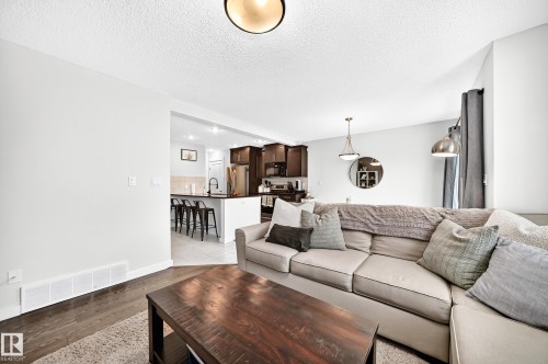 Wood-finish flooring with a neutral wall palette - 16832 53 Street Nw, Edmonton, AB 