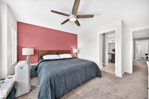 Slanted ceiling with a ceiling fan, recessed window, and carpeted flooring - 16832 53 Street Nw, Edmonton, AB 