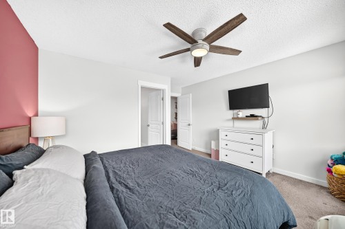 Ceiling fan with wood-finish blades and integrated lighting - 16832 53 Street Nw, Edmonton, AB 