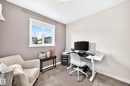 Recessed window with white trim, wall-mounted shelving, and neutral-toned carpeting - 16832 53 Street Nw, Edmonton, AB 