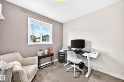 Recessed window with white trim, wall-mounted shelving, and neutral-toned carpeting - 