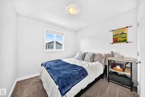 White walls with carpet flooring, a single window, and an overhead light fixture - 16832 53 Street Nw, Edmonton, AB 