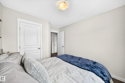 White interior doors with panel detailing, white trim, and light neutral wall paint - 16832 53 Street Nw, Edmonton, AB 