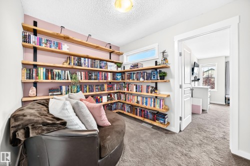Built-in shelving with wood-finish planks, recessed window, and white trim - 16832 53 Street Nw, Edmonton, AB 