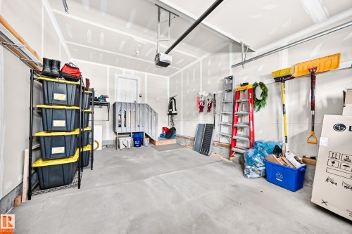 Concrete flooring garage with an automatic garage door opener and interior access door - 16832 53 Street Nw, Edmonton, AB 
