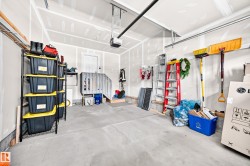 Concrete flooring garage with an automatic garage door opener and interior access door - 