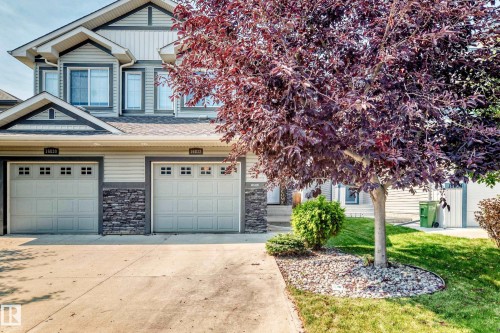 Multi-level façade with horizontal siding and stacked stone accents - 16832 53 Street Nw, Edmonton, AB 