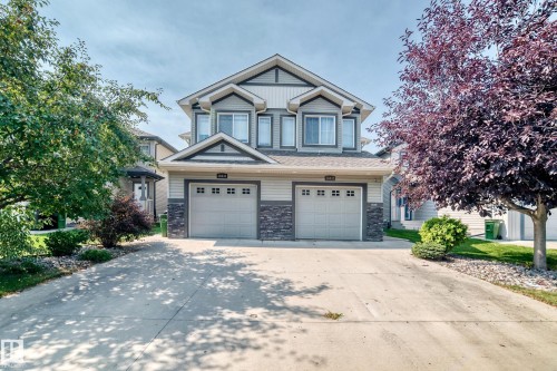 Two-story property with gray siding and stone accents - 16832 53 Street Nw, Edmonton, AB 