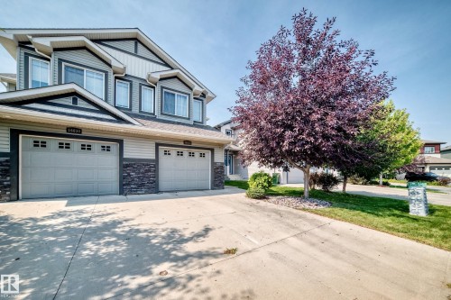 Two-story residence featuring light gray siding with dark gray trim accents - 16832 53 Street Nw, Edmonton, AB 