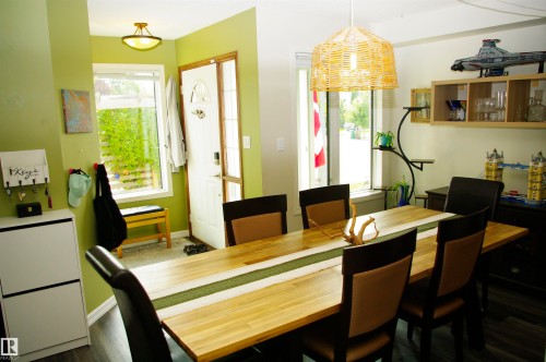 Hardwood flooring in a natural finish, white painted door, and a modern ceiling light fixture - 25 Hasen Close, St. Albert, AB 