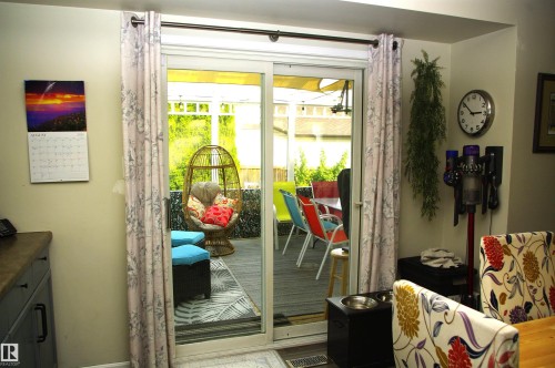 Sliding glass door leading to an outdoor deck area - 25 Hasen Close, St. Albert, AB 