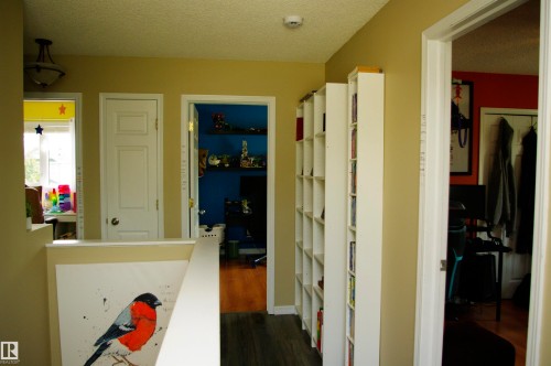 Hallway with light tan walls, recessed lighting, and wood-finish flooring - 25 Hasen Close, St. Albert, AB 