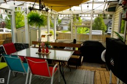 Screened patio with wood-finish flooring and a translucent overhead covering - 