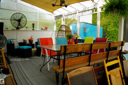 Enclosed sunroom featuring a transparent panel roof, slatted ceiling, and wall-mounted fan - 25 Hasen Close, St. Albert, AB 