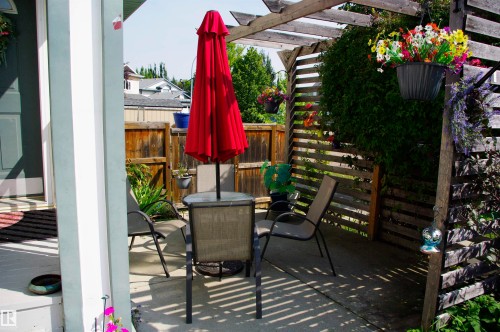 Private patio area featuring a wooden pergola and lattice - 25 Hasen Close, St. Albert, AB 