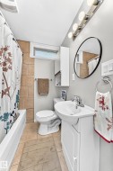 Built-in bathtub with subway tile surround, tile flooring, and a single vanity with storage - 