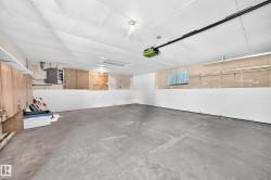 Expansive unfinished basement featuring a concrete floor, exposed ceiling, and integrated lighting - 