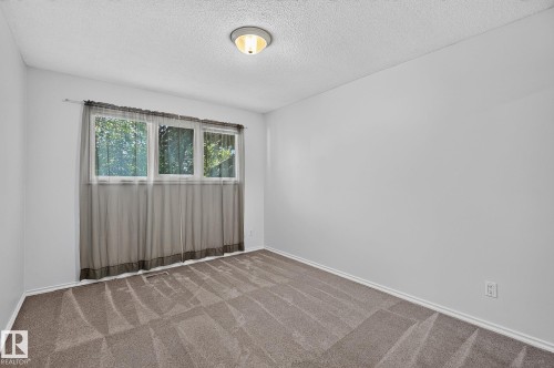 Neutral-toned wall paint with a window featuring a white frame and three panes - 16016 78A Avenue Nw, Edmonton, AB 