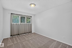 Neutral-toned wall paint with a window featuring a white frame and three panes - 