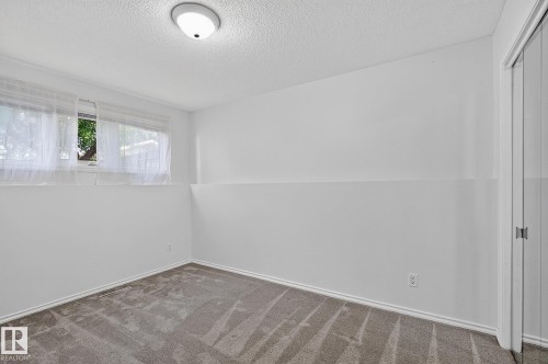 Recessed window, textured white walls, white trim, wall-to-wall carpet, flush mount ceiling light - 16016 78A Avenue Nw, Edmonton, AB 