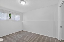 Recessed window, textured white walls, white trim, wall-to-wall carpet, flush mount ceiling light - 