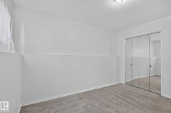 Carpeted flooring, mirrored sliding closet doors, and recessed lighting - 