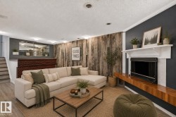 Fireplace with a wood mantle, wood-finish accent wall, and recessed lighting - 