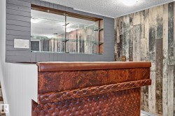 Built-in bar featuring a tufted leatherette front and a polished top - 